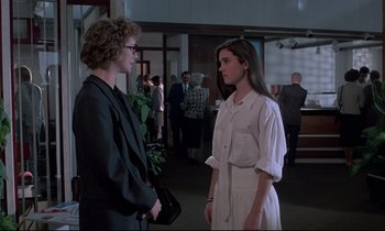 Movie still from “Phenomena” (1985), directed by Dario Argento – Two people standing next to each other in a room; Medium shot, Over the shoulder angle