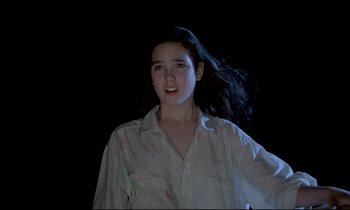 Movie still from “Phenomena” (1985), directed by Dario Argento – A young woman with long black hair in the dark; Close Up shot, Low angle