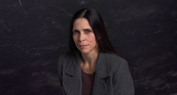 Movie still from “Pina” (2011), directed by Wim Wenders – A woman with long black hair wearing a gray jacket; Close Up shot, Low angle