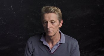 Movie still from “Pina” (2011), directed by Wim Wenders – A person wearing a blue shirt; Close Up shot, High angle