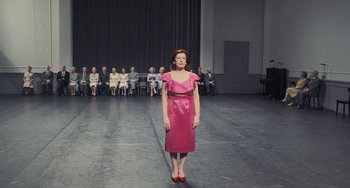 Movie still from “Pina” (2011), directed by Wim Wenders – A woman standing in front of a group of people; Wide shot, High angle