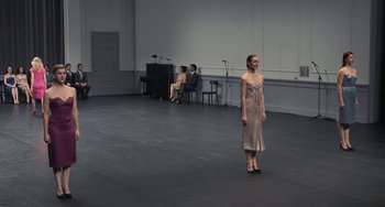 Movie still from “Pina” (2011), directed by Wim Wenders – A woman standing in front of a piano in an empty room; Wide shot, Over the shoulder angle
