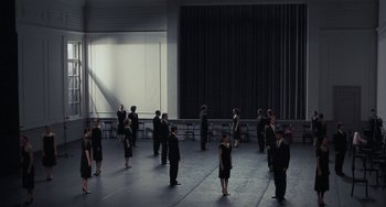 Movie still from “Pina” (2011), directed by Wim Wenders – A group of people standing in front of a stage; Extreme Wide shot, High angle