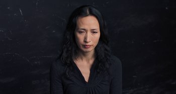 Movie still from “Pina” (2011), directed by Wim Wenders – A woman in a black shirt is posing for a picture; Close Up shot, High angle
