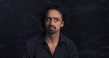 Movie still from “Pina” (2011), directed by Wim Wenders – A man in a black shirt is looking at the camera; Close Up shot, Overhead angle