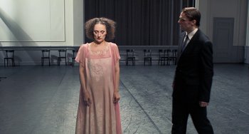 Movie still from “Pina” (2011), directed by Wim Wenders – A man and a woman standing in front of each other; Medium shot, Over the shoulder angle