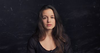 Movie still from “Pina” (2011), directed by Wim Wenders – A woman in a black shirt is posing for a picture; Close Up shot, Low angle