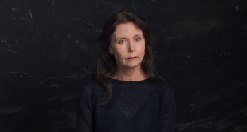 Movie still from “Pina” (2011), directed by Wim Wenders – A woman with long hair wearing a black shirt; Close Up shot, Low angle