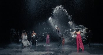 Movie still from “Pina” (2011), directed by Wim Wenders – A group of people standing in the water; Extreme Wide shot, High angle