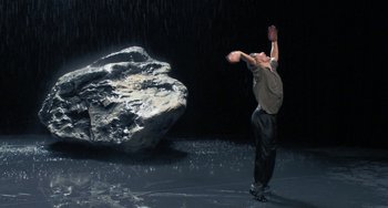 Movie still from “Pina” (2011), directed by Wim Wenders – A man is in the middle of an action scene; Wide shot, Low angle