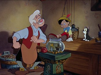 Movie still from “Pinocchio” (1940), directed by Jack Kinney – A painting of a man and a boy with a fish bowl in front of them; Medium shot, Low angle