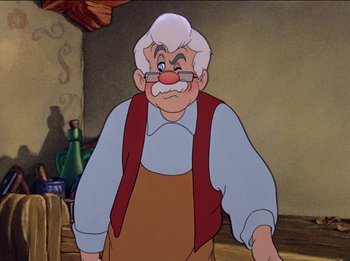 Movie still from “Pinocchio” (1940), directed by Jack Kinney – An old man with white hair and a mustache; Medium shot, Over the shoulder angle