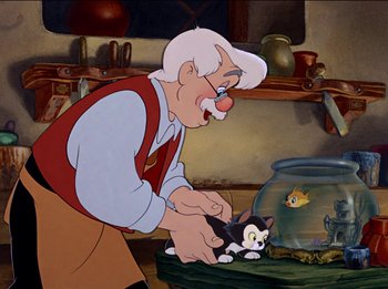 Movie still from “Pinocchio” (1940), directed by Jack Kinney – An old man holding a cat in front of a fish bowl; Medium shot, Over the shoulder angle