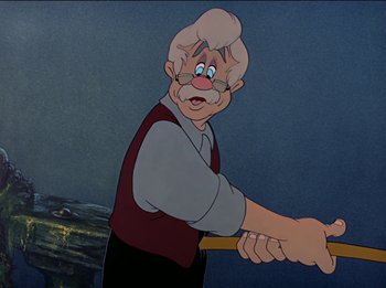 Movie still from “Pinocchio” (1940), directed by Jack Kinney – An old man holding a stick in his hand; Medium shot, Over the shoulder angle