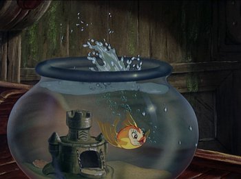 Movie still from “Pinocchio” (1940), directed by Jack Kinney – An aquarium with a fish in it and a castle in the background; Wide shot, High angle