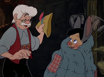 Movie still from “Pinocchio” (1940), directed by Jack Kinney – An old man holding a shoe next to an older man; Medium shot, Over the shoulder angle