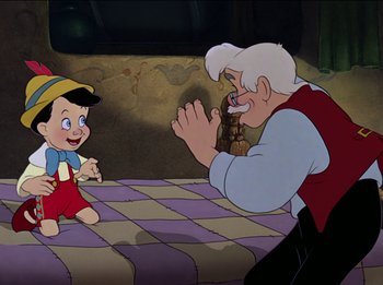 Movie still from “Pinocchio” (1940), directed by Jack Kinney – An old man and a little boy are playing together; Medium shot, Over the shoulder angle