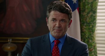 Movie still from “Pitch Perfect 2” (2015), directed by Elizabeth Banks – A person wearing a suit and tie; Close Up shot, Over the shoulder angle