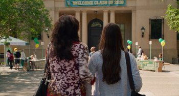 Movie still from “Pitch Perfect 2” (2015), directed by Elizabeth Banks – Two young women are walking in front of a building; Wide shot, Over the shoulder angle