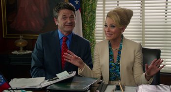 Movie still from “Pitch Perfect 2” (2015), directed by Elizabeth Banks – A man and a woman sitting at a table talking; Medium shot, Over the shoulder angle