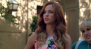 Movie still from “Pitch Perfect 2” (2015), directed by Elizabeth Banks – A beautiful young woman with long red hair; Close Up shot, Over the shoulder angle
