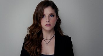 Movie still from “Pitch Perfect 2” (2015), directed by Elizabeth Banks – A beautiful young lady with long brown hair wearing a black jacket; Close Up shot, Overhead angle