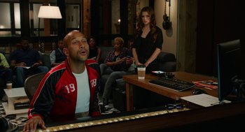 Movie still from “Pitch Perfect 2” (2015), directed by Elizabeth Banks – A group of people sitting in a living room; Medium shot, Over the shoulder angle