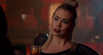 Movie still from “Pitch Perfect 2” (2015), directed by Elizabeth Banks – A beautiful blonde woman holding a drink in her hand; Close Up shot, Over the shoulder angle