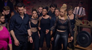 Movie still from “Pitch Perfect 2” (2015), directed by Elizabeth Banks – A group of young people standing around each other; Medium shot, Low angle