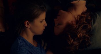 Movie still from “Pitch Perfect 2” (2015), directed by Elizabeth Banks – Two women are looking at each other in the dark; Close Up shot, Overhead angle