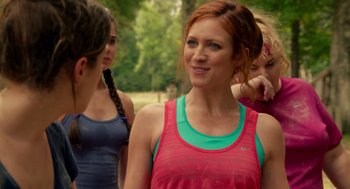Movie still from “Pitch Perfect 2” (2015), directed by Elizabeth Banks – A group of women standing next to each other in a park; Close Up shot, Over the shoulder angle