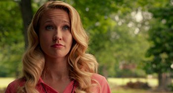 Movie still from “Pitch Perfect 2” (2015), directed by Elizabeth Banks – A woman with long blonde hair wearing a pink shirt; Close Up shot, Over the shoulder angle