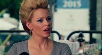 Movie still from “Pitch Perfect 2” (2015), directed by Elizabeth Banks – A woman with blonde hair is talking on a microphone; Close Up shot, Over the shoulder angle