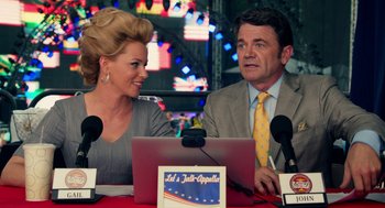 Movie still from “Pitch Perfect 2” (2015), directed by Elizabeth Banks – A man and a woman sitting in front of a laptop computer; Medium shot, Over the shoulder angle