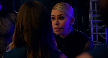 Movie still from “Pitch Perfect 2” (2015), directed by Elizabeth Banks – A woman is talking to another woman in a dark room; Close Up shot, Over the shoulder angle