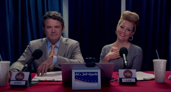 Movie still from “Pitch Perfect 2” (2015), directed by Elizabeth Banks – A man and a woman sitting in front of microphones; Medium shot, Low angle