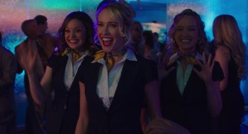 Movie still from “Pitch Perfect 3” (2017), directed by Trish Sie – A group of women standing next to each other in a room; Medium shot, Low angle