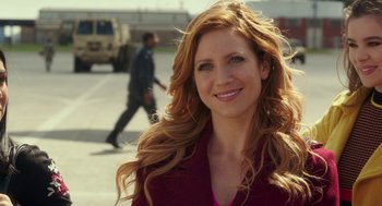 Movie still from “Pitch Perfect 3” (2017), directed by Trish Sie – A beautiful woman with long red hair smiling for the camera; Close Up shot, Over the shoulder angle