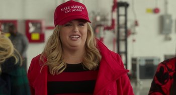Movie still from “Pitch Perfect 3” (2017), directed by Trish Sie – A woman in a red jacket and a red hat; Medium shot, Over the shoulder angle