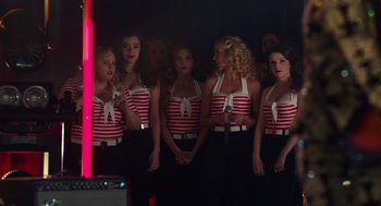 Movie still from “Pitch Perfect 3” (2017), directed by Trish Sie – A group of women standing next to each other in a room; Medium shot, High angle