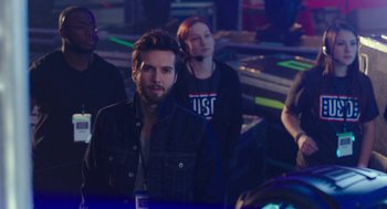 Movie still from “Pitch Perfect 3” (2017), directed by Trish Sie – A group of people standing around in a room; Medium shot, Over the shoulder angle