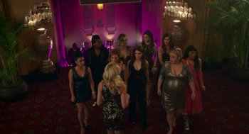 Movie still from “Pitch Perfect 3” (2017), directed by Trish Sie – A group of women standing around in a room; Wide shot, High angle