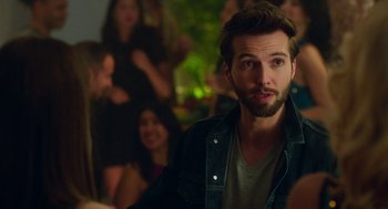 Movie still from “Pitch Perfect 3” (2017), directed by Trish Sie – A man with a goatee and a beard looking at the camera; Close Up shot, Over the shoulder angle