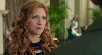 Movie still from “Pitch Perfect 3” (2017), directed by Trish Sie – A person with long red hair; Close Up shot, Over the shoulder angle
