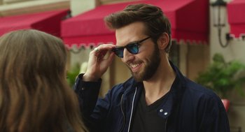 Movie still from “Pitch Perfect 3” (2017), directed by Trish Sie – A man with a beard wearing sunglasses and a jacket; Close Up shot, Over the shoulder angle