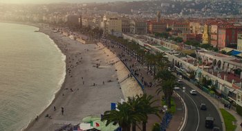 Movie still from “Pitch Perfect 3” (2017), directed by Trish Sie – A view of a beach with people walking on it; Extreme Wide shot, High angle