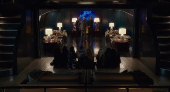 Movie still from “Pitch Perfect 3” (2017), directed by Trish Sie – A group of people sitting in front of a stage; Wide shot, High angle