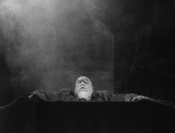 A man laying on the ground with his eyes closed