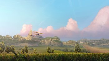 Movie still from “Planes” (2013), directed by Klay Hall – An airplane is flying over a field with mountains in the background; Extreme Wide shot, Low angle