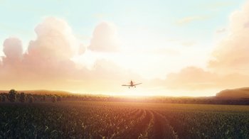 Movie still from “Planes” (2013), directed by Klay Hall – An airplane is flying over a corn field at sunset; Extreme Wide shot, High angle